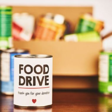 Canned goods in a donation box.