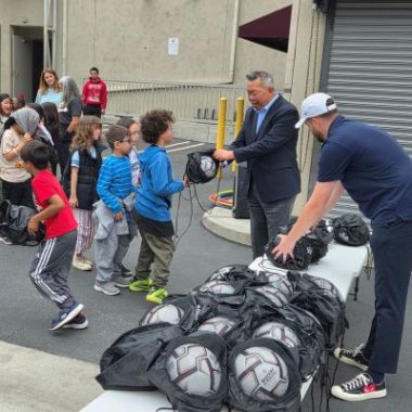 Students receive soccer bags and equipment at Odyssey Charter School in Altadena during the launch of the “Soccer at Schools” initiative.